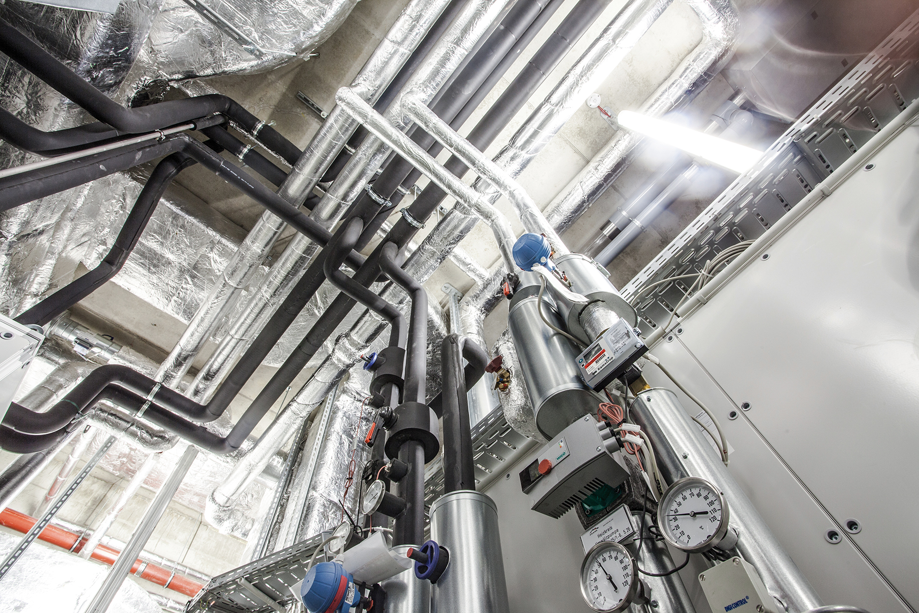 Media supply. View of the ceiling with pipes and gauges.